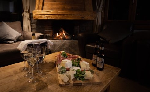 Open fire and cheese board in catered Ski Chalet Morzine, France