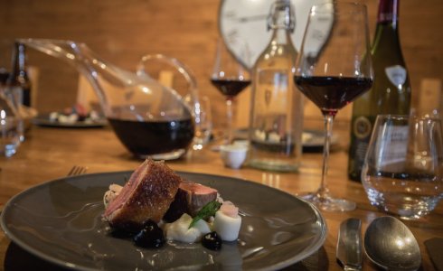 Roast duck and wine in catered ski chalet