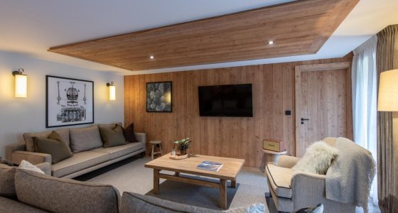 Comfortable lounge with sofa, armchair and coffee table in Apartment Chamossière, Morzine