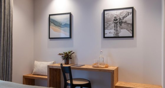 Bedroom with framed prints and writing table in Apartment Abeille, Morzine