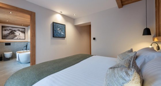 Bedroom with a view through to the en-suite bathroom in Apartment Abeille, Morzine