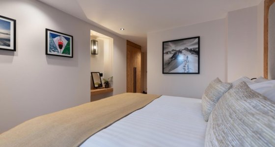 Spacious bedroom with large bed and framed artwork in Apartment Chamossière, Morzine