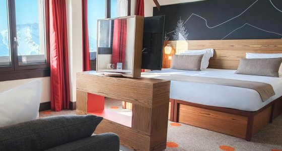 Family room with double bed, sofa and mountain views