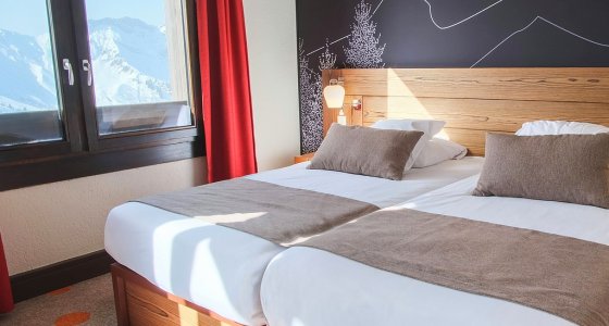 Twin bedroom with snowy mountain views