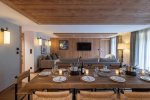 Dining table laid for dinner with lounge area behind in Apartment Chamossière, Morzine