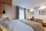 Bedroom with double bed and writing desk in Apartment Abeille, Morzine