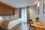 Bedroom with double bed and desk by the window in Apartment Abeille, Morzine