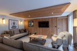 Comfortable lounge with sofa, armchair and coffee table in Apartment Chamossière, Morzine