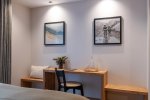 Bedroom with framed prints and writing table in Apartment Abeille, Morzine
