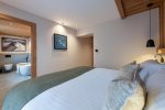 Bedroom with a view through to the en-suite bathroom in Apartment Abeille, Morzine