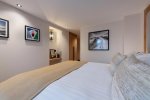 Spacious bedroom with large bed and framed artwork in Apartment Chamossière, Morzine