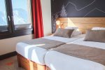 Twin bedroom with snowy mountain views